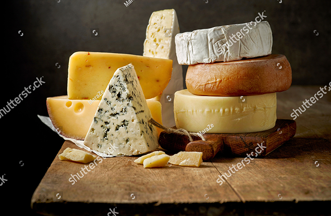 stock-photo-various-types-of-cheese-on-rustic-wooden-table-533946397.png